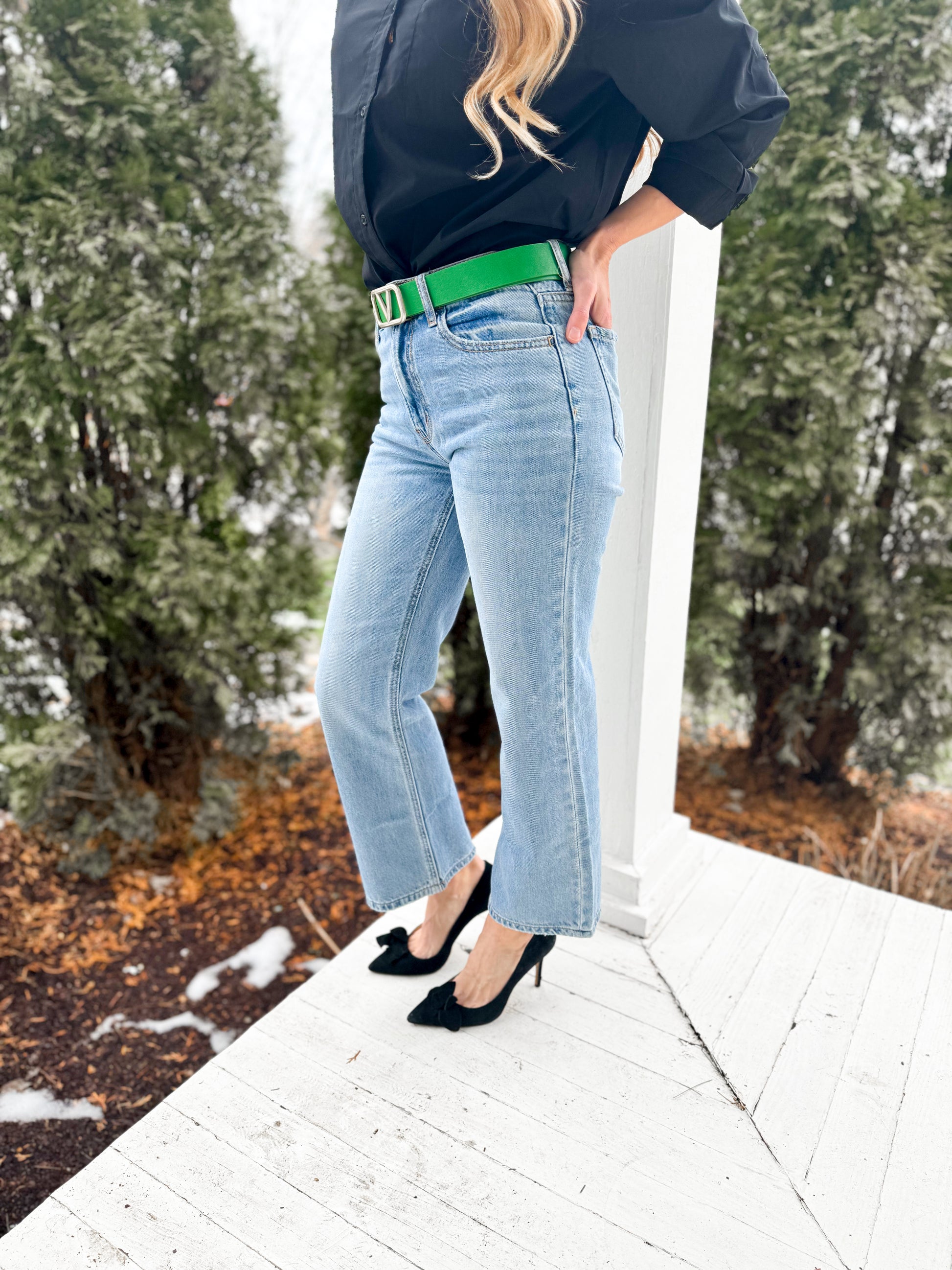 woman on a porch wearing HIGH RISE straight DAD denim JEANS with black button down top and black heels 