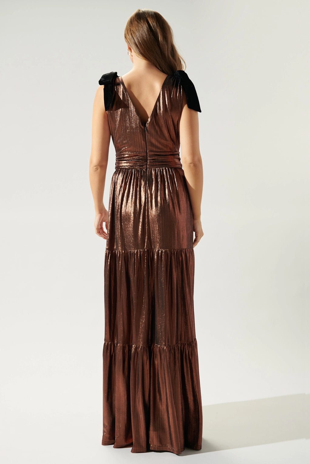 back view of Liquid Satin Evening Maxi Dress in copper with black velvet bows on the sleeves