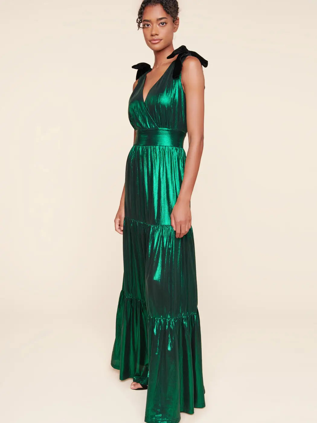 side view of Liquid Satin Evening Maxi Dress in emerald with black velvet bows on the sleeves