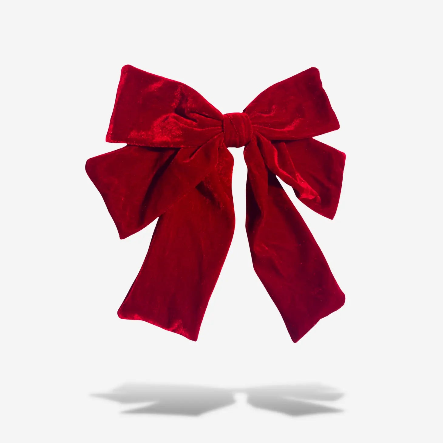 big red velvet bow barette on white background